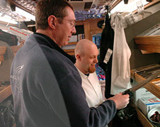 Darryl shows Joe Troupe some of the knives offered in his mobile knife sharpening vehicle